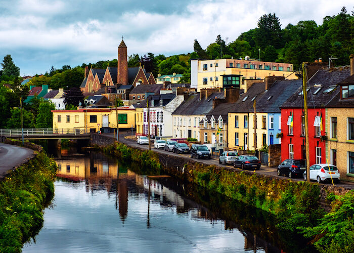 Donegal, Ireland. Beautiful landscape in Donegal, Ireland with river and colorful houses. Cloudy sky in summer, old bridge over the river